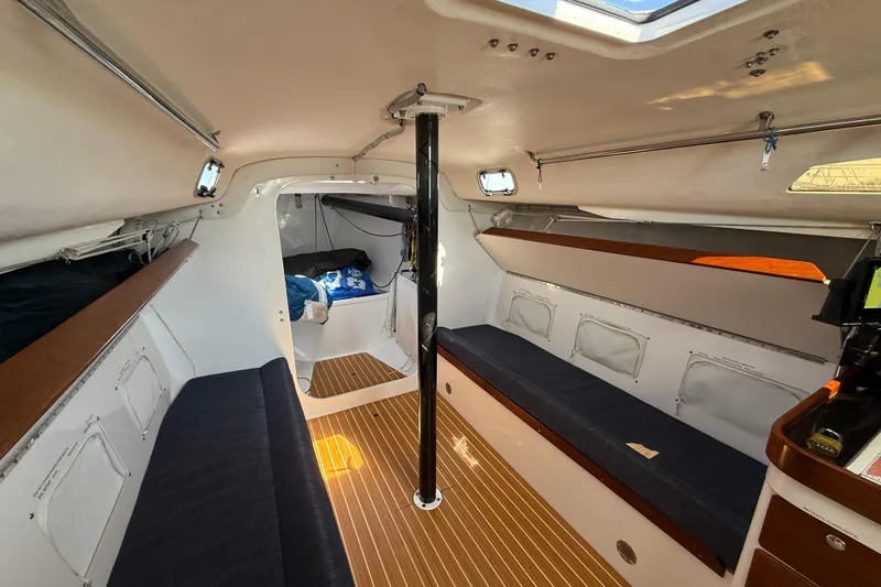Slide: The Image of Interior of 2018 J Boats J/121 sailboat with wooden flooring and seating. - 22