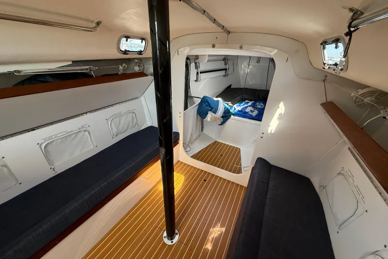 Slide: The Image of Interior of 2018 J Boats J/121 sailboat with cozy seating and wooden flooring. - 23