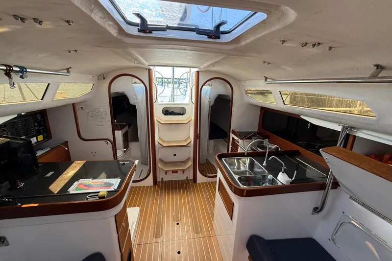 Slide: The Image of Interior of 2018 J Boats J/121 sailboat, featuring modern kitchen and seating area. - 27