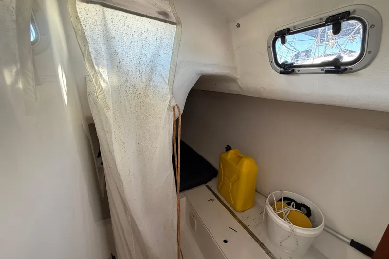 Slide: The Image of Interior of 2018 J Boats J/121 sailboat with storage area and porthole. - 29