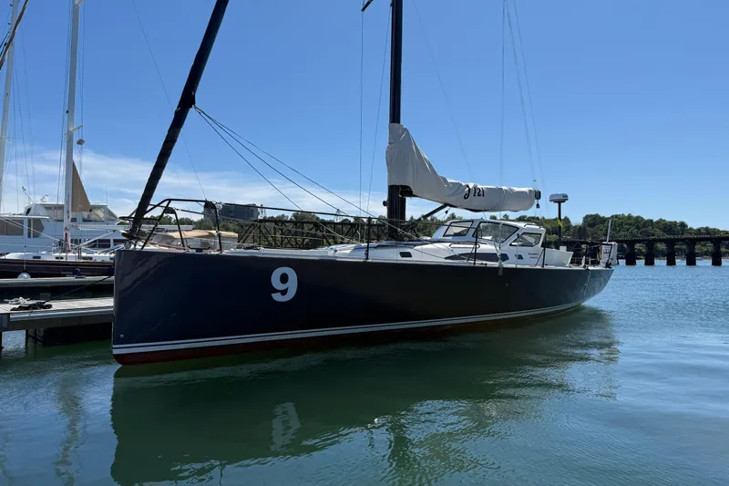 Slide: The Image of 2018 J Boats J/121 sailboat docked in a marina under clear blue skies. - 3