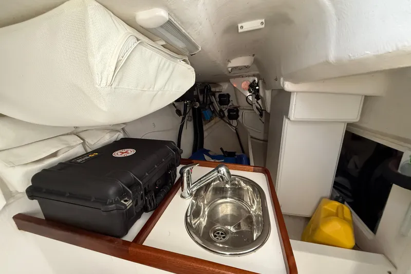 Slide: The Image of Interior of 2018 J Boats J/121 sailboat with sink and storage compartments. - 32