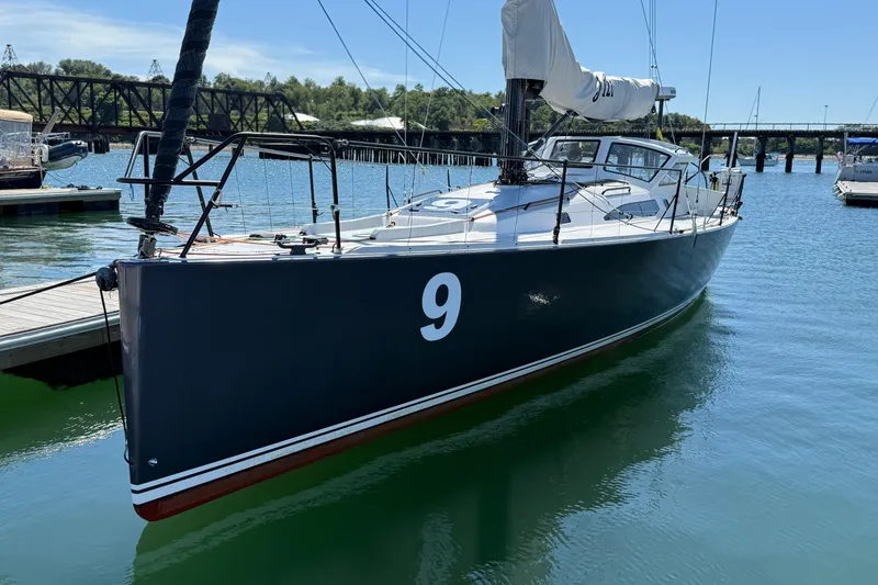 Slide: The Image of 2018 J Boats J/121 sailboat docked, featuring sleek design and number 9 on hull. - 4