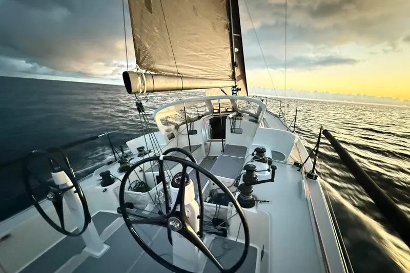 Slide: The Image of 2018 J Boats J/121 sailing at sunset, showcasing sleek design and dual steering wheels. - 40