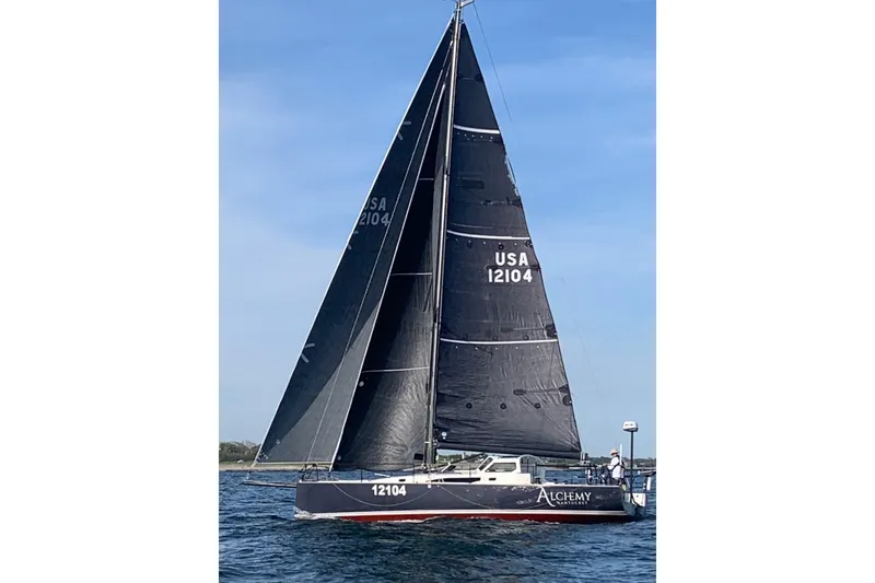 Slide: The Image of 2018 J Boats J/121 sailboat with black sails on the water. - 41
