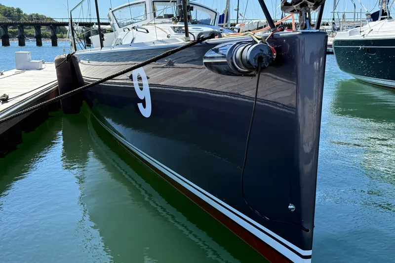 Slide: The Image of 2018 J Boats J/121 sailboat docked, sleek hull design, number 9 visible. - 44