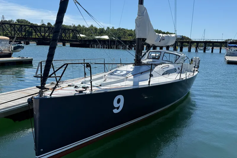 Slide: The Image of 2018 J Boats J/121 sailboat docked in a marina, featuring sleek design and number 9. - 5