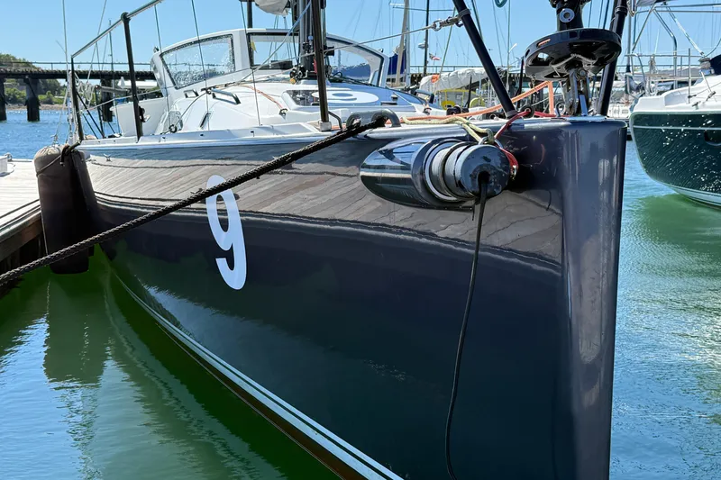 Slide: The Image of 2018 J Boats J/121 sailboat docked, featuring sleek design and number nine on the hull. - 6
