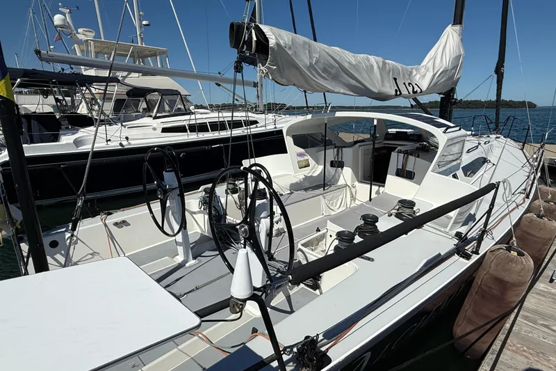 Slide: The Image of 2018 J Boats J/121 sailboat docked, featuring dual steering wheels and sleek design. - 9