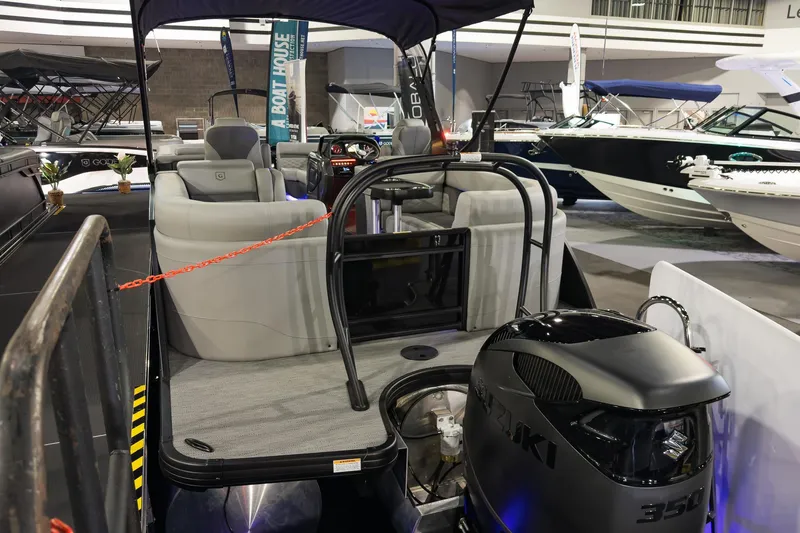 Slide: The Image of 2026 Godfrey Monaco 255 Split Bench boat with Suzuki engine at a boat show. - 11