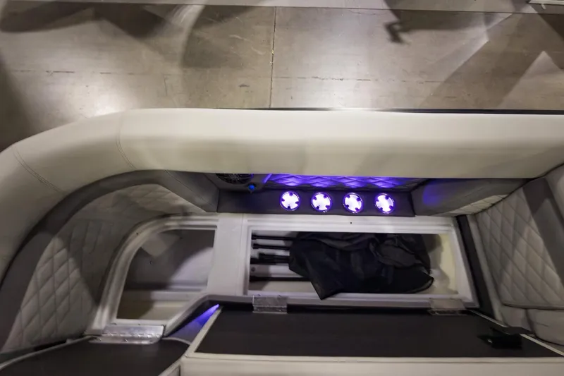 Slide: The Image of Interior of 2026 Godfrey Monaco 255 Split Bench with illuminated storage compartment. - 14