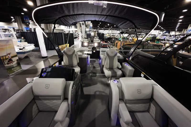 Slide: The Image of 2026 Godfrey Monaco 255 Split Bench pontoon boat interior at a boat show. - 17