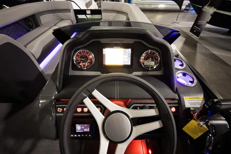 Slide: The Image of 2026 Godfrey Monaco 255 Split Bench dashboard with illuminated controls and modern steering wheel. - 22
