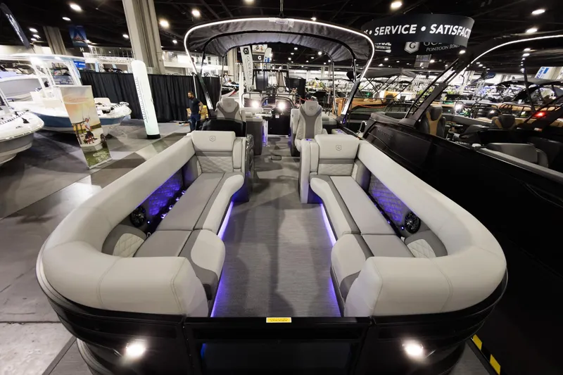 Slide: The Image of 2026 Godfrey Monaco 255 Split Bench pontoon boat interior at a boat show. - 5
