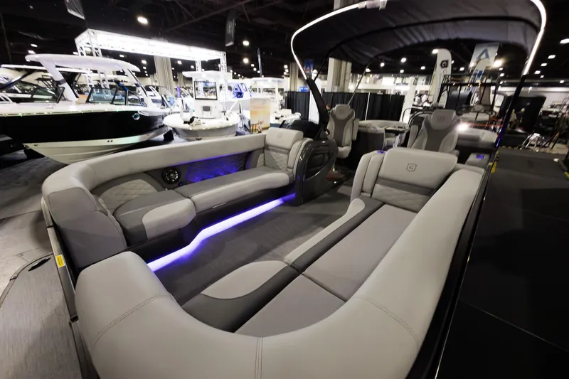 Slide: The Image of 2026 Godfrey Monaco 255 Split Bench pontoon boat interior at a boat show. - 6