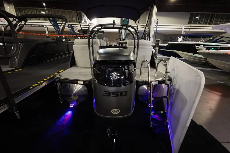 Slide: The Image of 2026 Godfrey Monaco 255 Split Bench boat with 350 engine, showcased indoors. - 9