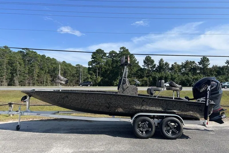 The Image of 2026 Xpress H22 boat on trailer, parked outdoors under clear blue sky. - 1