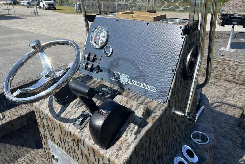 Slide: The Image of 2026 Xpress H22 boat dashboard with steering wheel and control panel. - 15