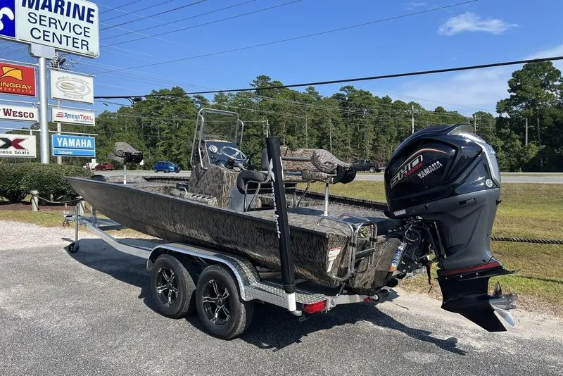 Slide: The Image of 2026 Xpress H22 boat with Yamaha motor at marine service center. - 2