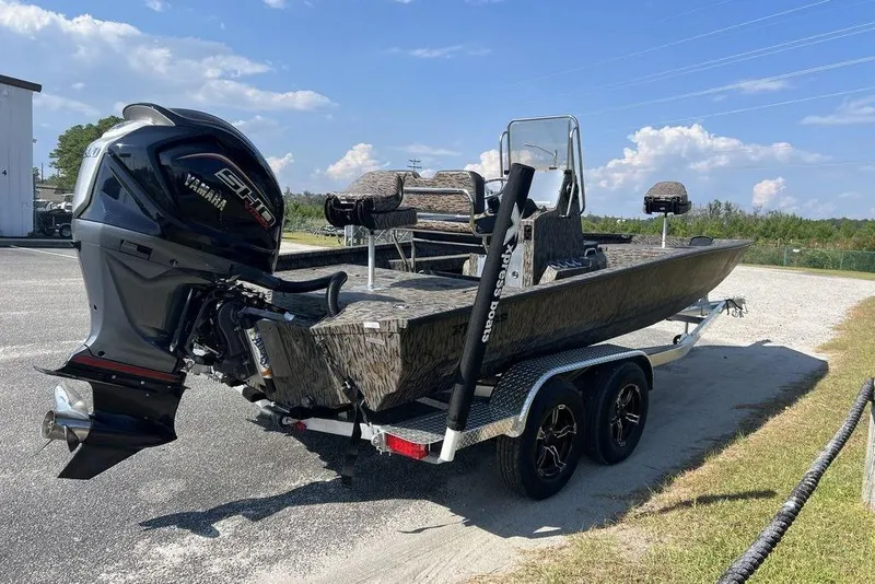 Slide: The Image of 2026 Xpress H22 boat with Yamaha engine on a trailer, parked outdoors. - 3