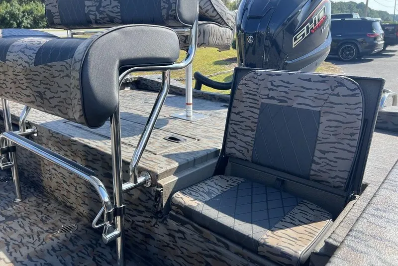 Slide: The Image of 2026 Xpress H22 boat interior with camo seats and powerful outboard motor. - 9