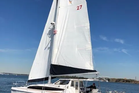The Image of Sailing catamaran Gemini Legacy 2013 on open water under clear blue sky. - 0