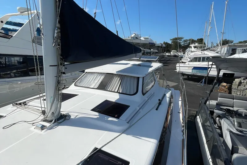 Slide: The Image of Sailboat docked at marina, Gemini Legacy 2013 model, surrounded by other boats. - 11