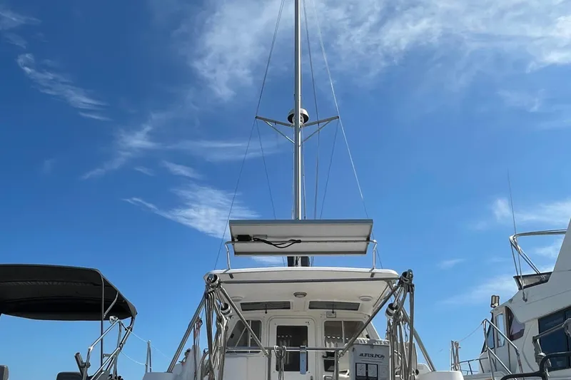 Slide: The Image of Sailboat with tall mast under clear blue sky, Gemini Legacy 2013 model. - 2