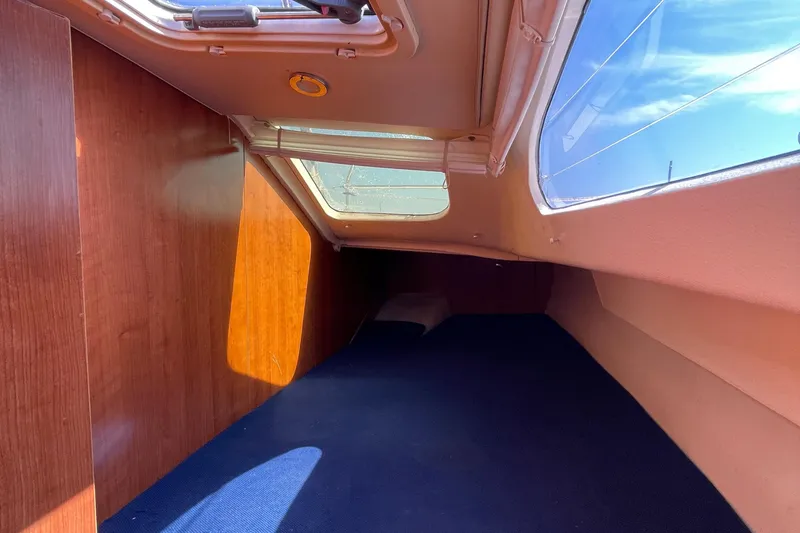 Slide: The Image of Interior cabin of 2013 Gemini Legacy boat with wooden paneling and skylight. - 24