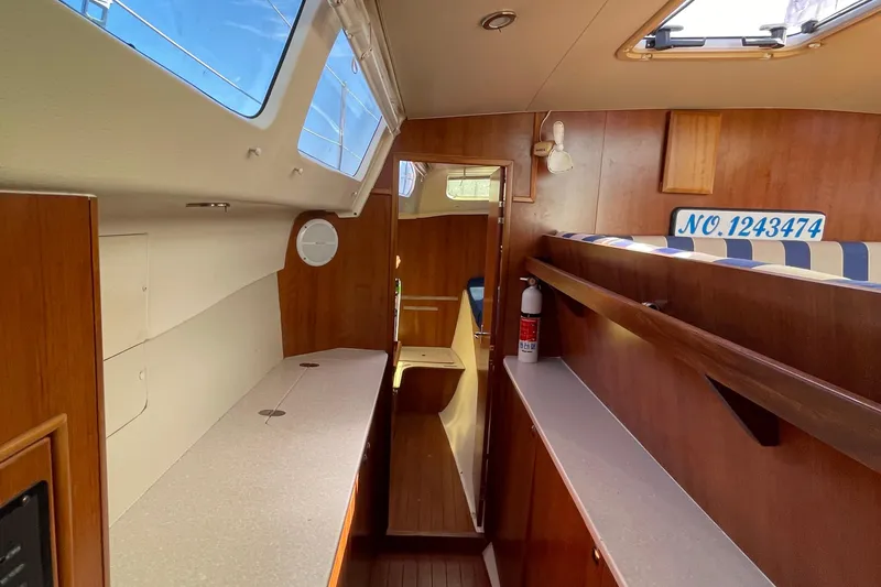 Slide: The Image of Interior of 2013 Gemini Legacy boat with wood finish and striped seating. - 27