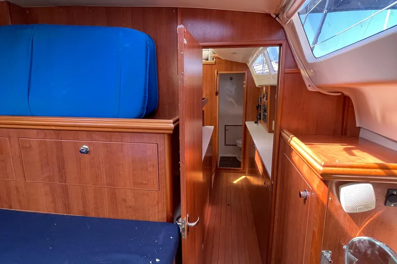 Slide: The Image of Interior of 2013 Gemini Legacy boat with wooden cabinetry and blue seating. - 28