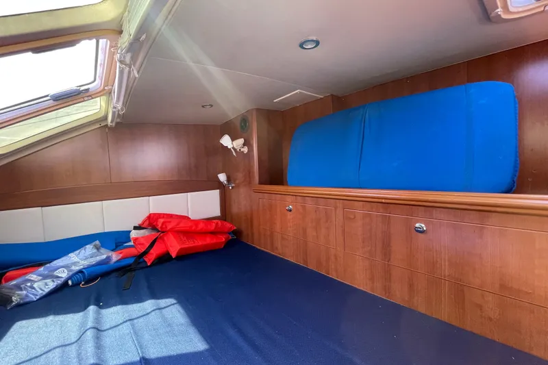 Slide: The Image of Interior cabin of 2013 Gemini Legacy boat with wooden finish and life jackets. - 29