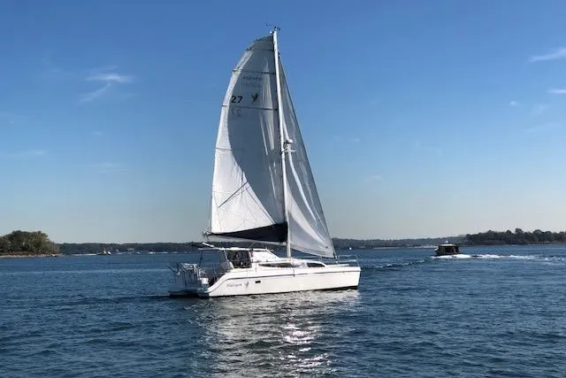 Slide: The Image of Sailboat Gemini Legacy 2013 on calm waters under clear blue sky. - 31