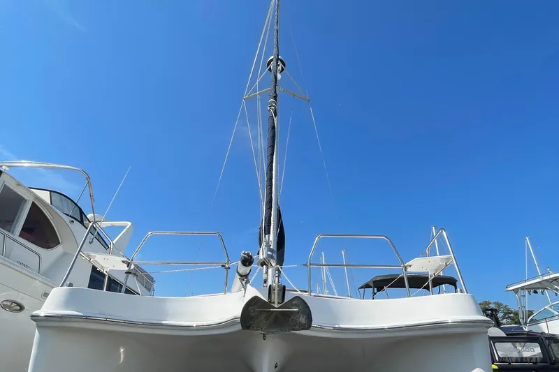 Slide: The Image of 2013 Gemini Legacy sailboat with blue sky background, docked among other boats. - 4
