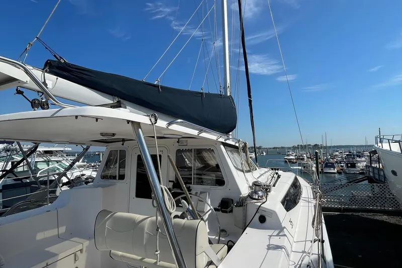 Slide: The Image of Sailboat docked at marina, Gemini Legacy 2013 model, under clear blue sky. - 8
