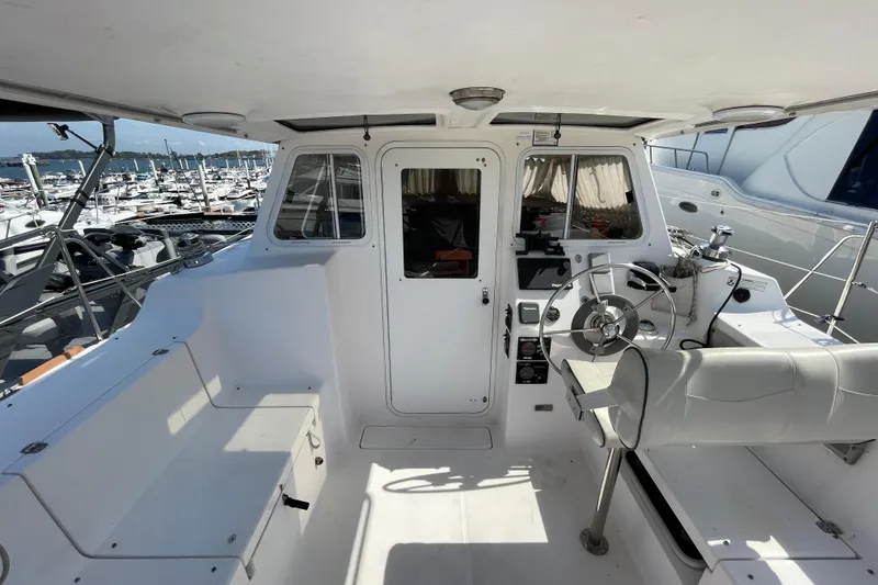 Slide: The Image of Interior view of a 2013 Gemini Legacy boat cockpit with steering wheel and seating. - 9