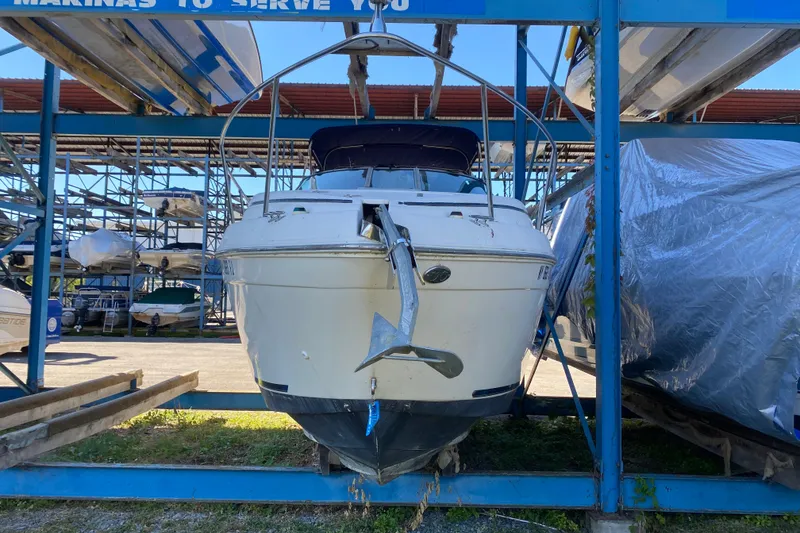 Slide: The Image of 2003 Rinker Fiesta Vee 270 boat stored in a marina rack, front view. - 2