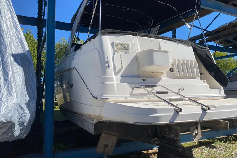 Slide: The Image of 2003 Rinker Fiesta Vee 270 boat on a storage rack, rear view. - 6
