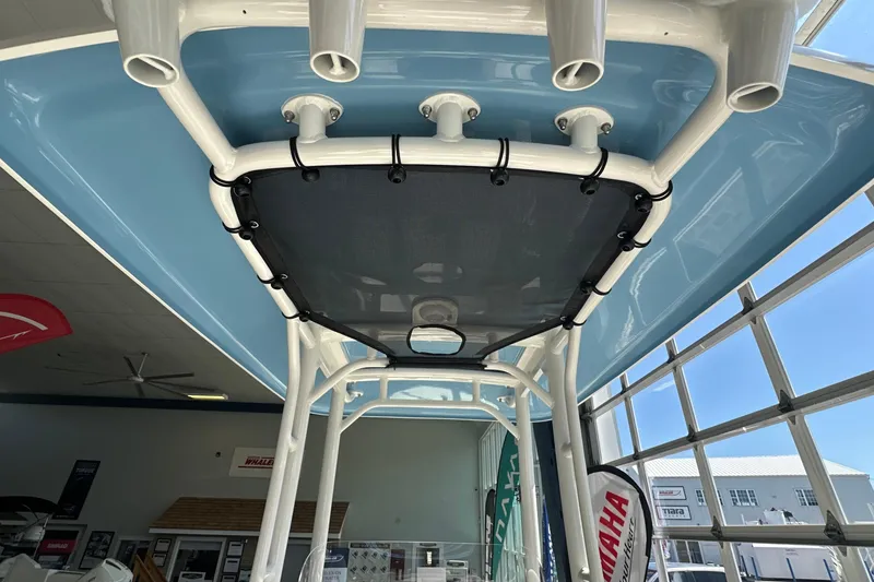 Slide: The Image of 2026 Boston Whaler 210 Montauk boat interior with rod holders and blue canopy. - 11