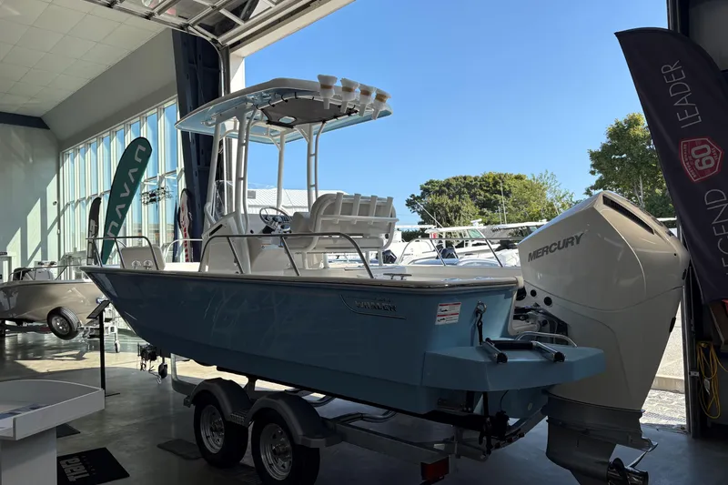 Slide: The Image of 2026 Boston Whaler 210 Montauk boat in showroom with Mercury engine. - 18
