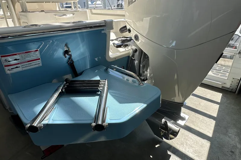 Slide: The Image of 2026 Boston Whaler 210 Montauk boat with ladder and outboard motor detail. - 2