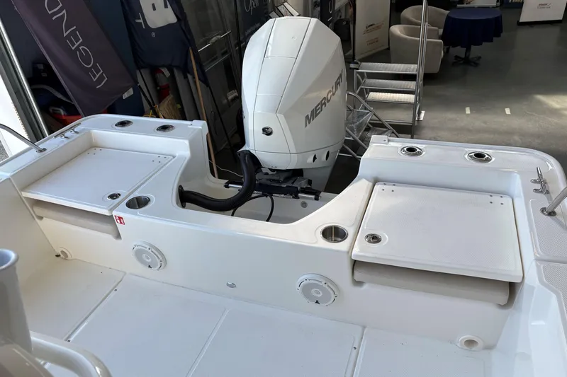 Slide: The Image of 2026 Boston Whaler 210 Montauk boat interior with Mercury engine, showcasing seating and storage. - 4