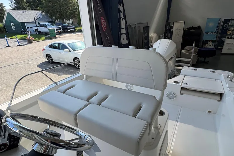 Slide: The Image of 2026 Boston Whaler 210 Montauk boat interior with steering wheel and seating. - 8