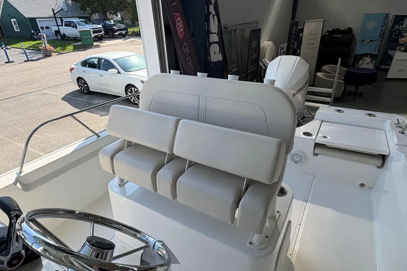 Slide: The Image of 2026 Boston Whaler 210 Montauk boat interior with steering wheel and seating. - 9