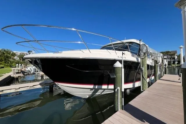 Slide: The Image of 2022 Regal 38 XO yacht docked at marina under clear blue sky. - 12