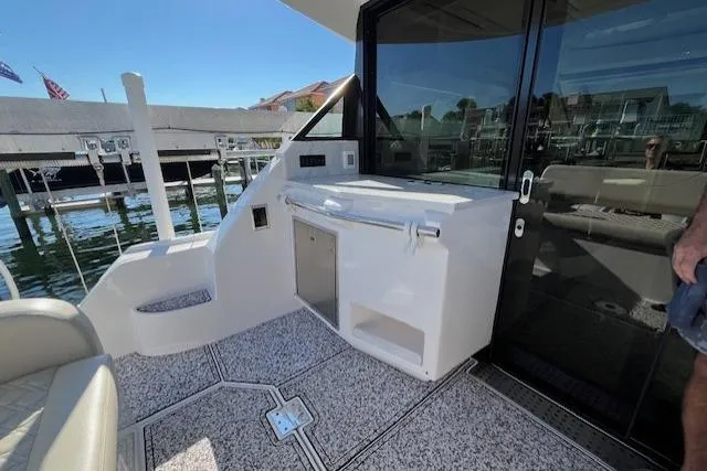 Slide: The Image of 2022 Regal 38 XO yacht deck with sleek design and modern amenities. - 13
