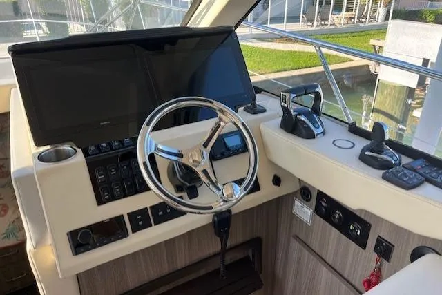 Slide: The Image of Helm of 2022 Regal 38 XO boat with modern controls and steering wheel. - 16