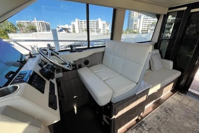 Slide: The Image of 2022 Regal 38 XO yacht interior with modern helm and plush seating. - 19