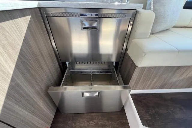 Slide: The Image of Stainless steel drawer in 2022 Regal 38 XO yacht interior, featuring modern wood paneling. - 23