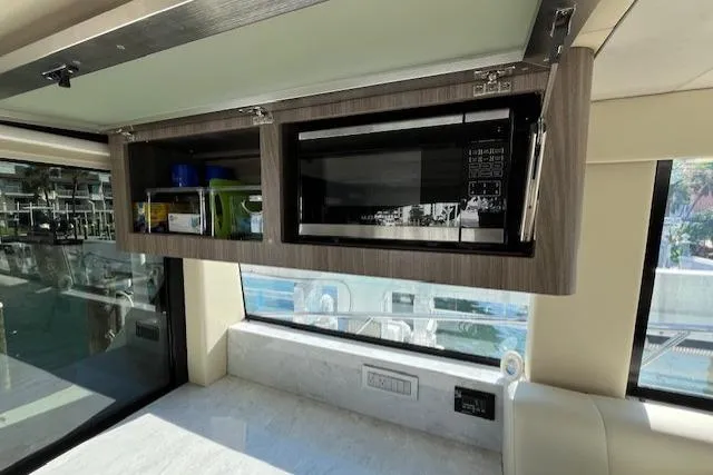 Slide: The Image of 2022 Regal 38 XO yacht interior with microwave and storage cabinet. - 25